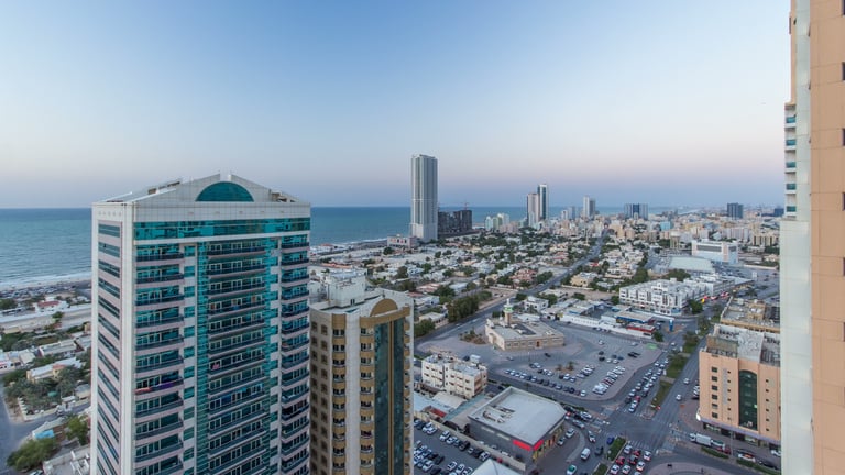 Cityscape of Ajman from rooftop day to night timelapse. Ajman is the capital of the emirate of Ajman in the United Arab Emirates