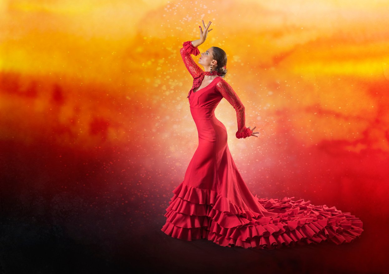 Spanish woman dancing flamenco on orange background