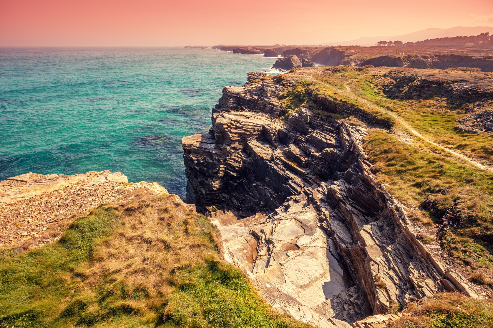 Seascape on a sunny day. Rocky sea coast on the Beach Playa de Las Catedrales in Ribadeo, Galicia, Spain